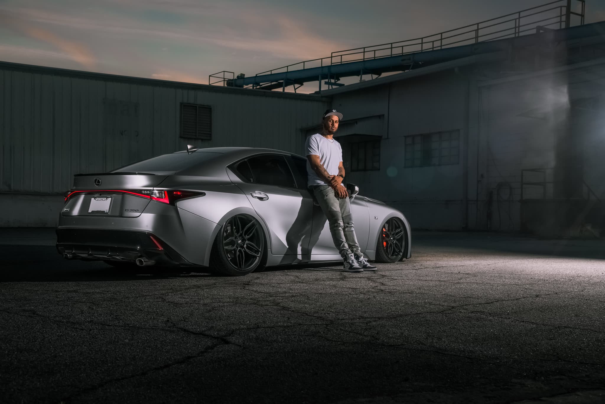 Man leaning on lowered vehicle